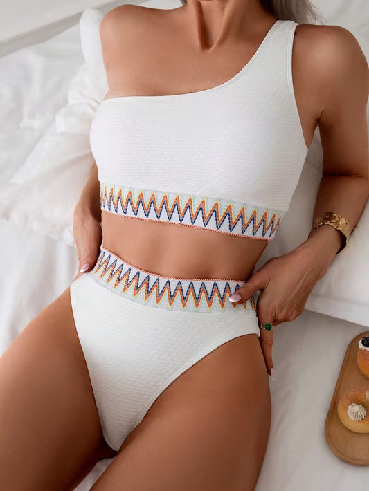 This One-Shoulder White Swimsuit for Women Showcases a Vibrant Wave Design.